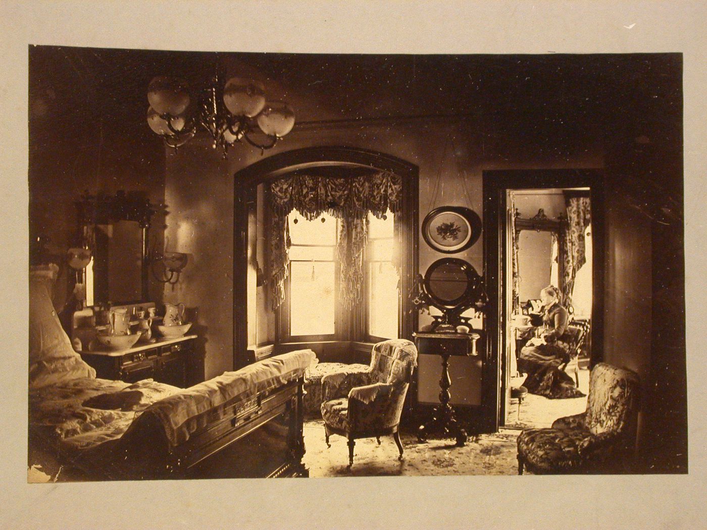 Rozenhof, Residence of S. R. Van Duzer, interior view of bedroom, showing woman seated in another room, Newburgh, New York
