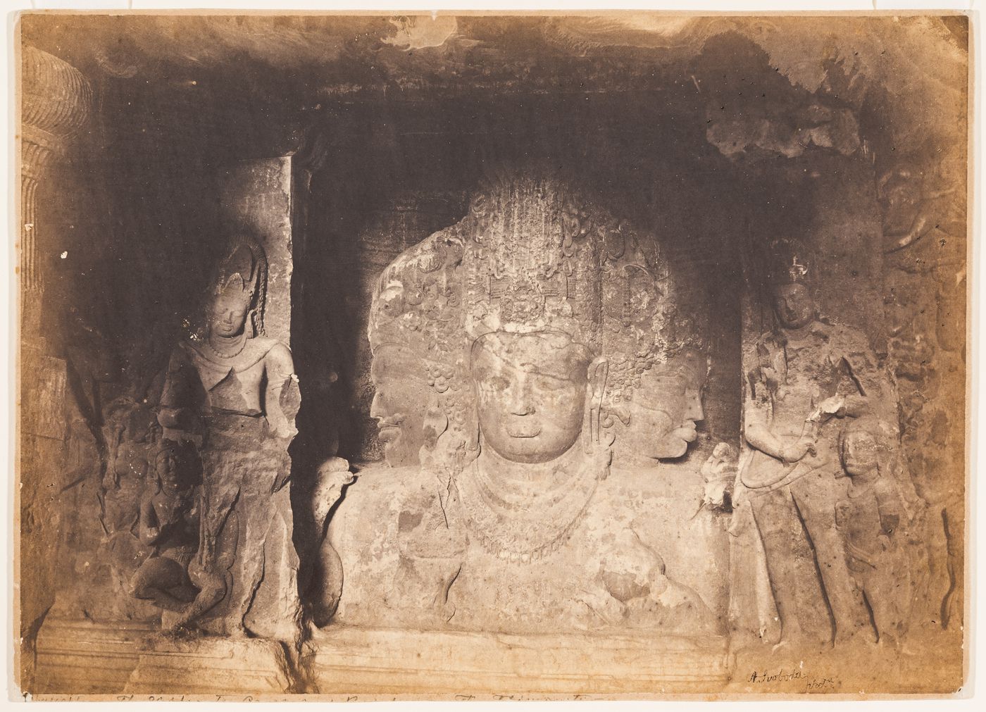 View of the triple-headed bust of Shiva (also known as the Mahesvara, the Mahesa-murti and the Sadashiva), Main Shrine, Cave No. 1 (also known as the Mahadeva Temple, the Shiva Cave and the Great Cave), Elephanta Caves, Elephanta Island, India