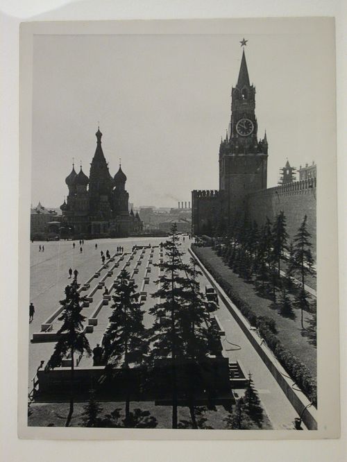 View of Red Square showing the tribunals adjacent to the stone Lenin Mausoleum in the foreground and Saint Basil Cathedral and the Spasskaia Tower in the background, Moscow