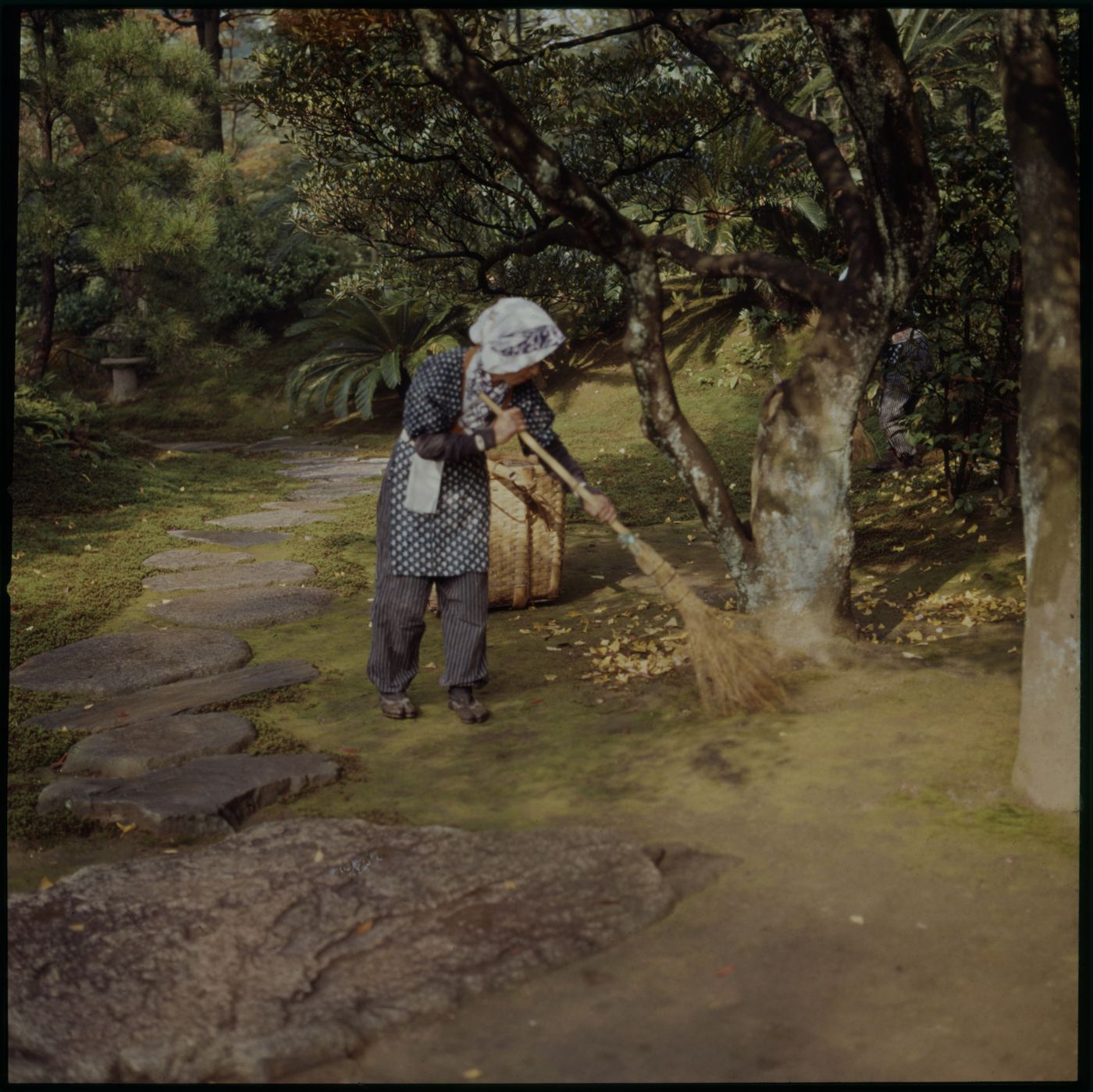 Person sweeping on grounds of Katsura Imperial Villa, Kyoto, Japan