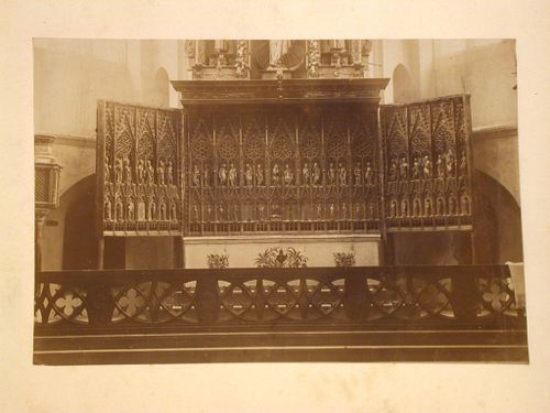 View of a triptych altarpiece behind a chancel screen, England [?]