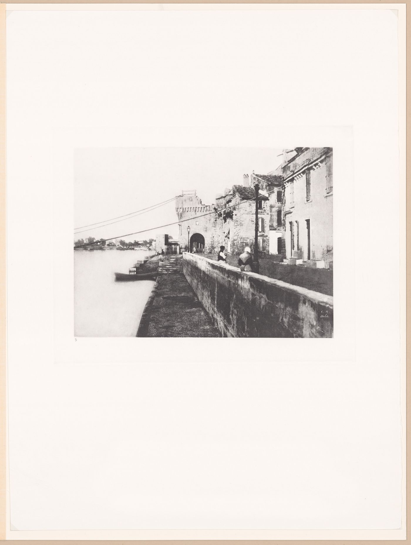 View of river, river wall, houses and fortifications, Arles, France