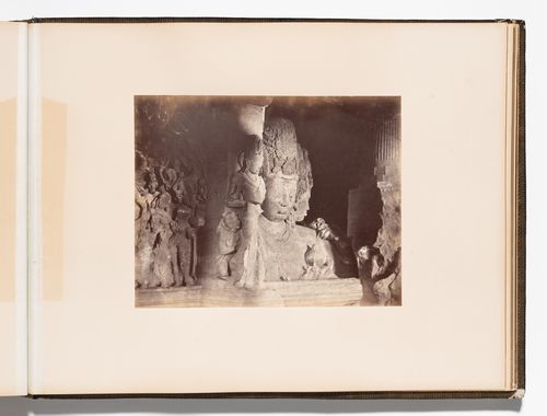 Partial view of the triple-headed bust of Shiva (also known as the Mahesvara, Mahesa-murti and Sadashiva) with reliefs on left, Main Shrine, Cave No. 1 (also known as Mahadeva Temple, Shiva Cave and Great Cave), Elephanta Caves, Elephanta Island, India