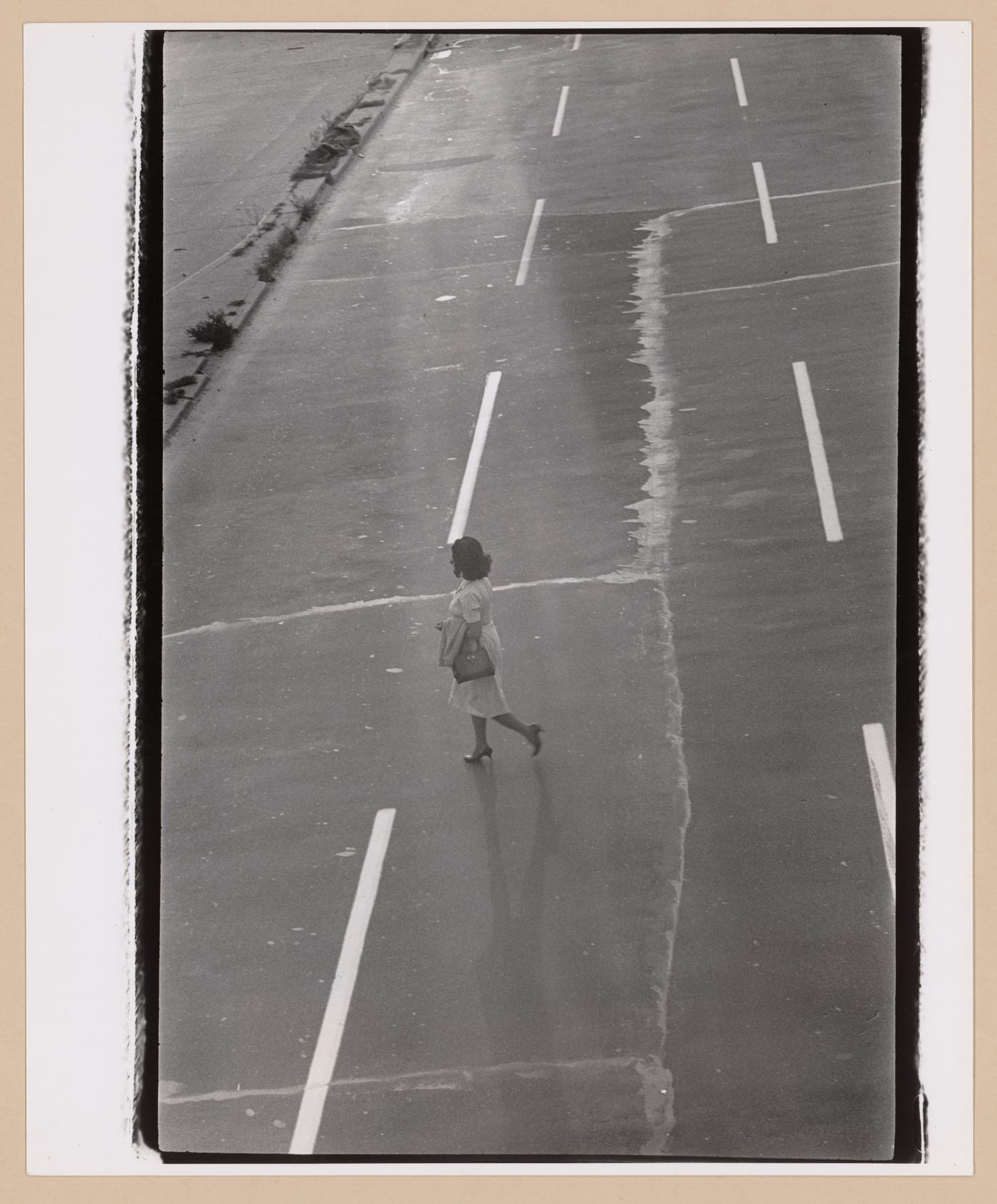 View of a woman walking across a highway, New York City [?], United States