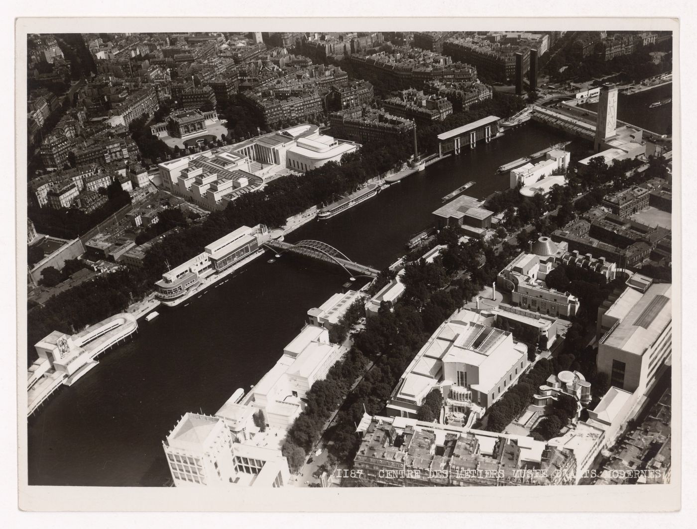 Aerial view of the Seine, bridges and buildings, including Les Musées d'Art Moderne, the Pavillons de l'Hygiène, du Yachting à voile, de la Sécurité, du Tourisme and du Bois français, from the Tour Eiffel, 1937 Exposition internationale, Paris, France