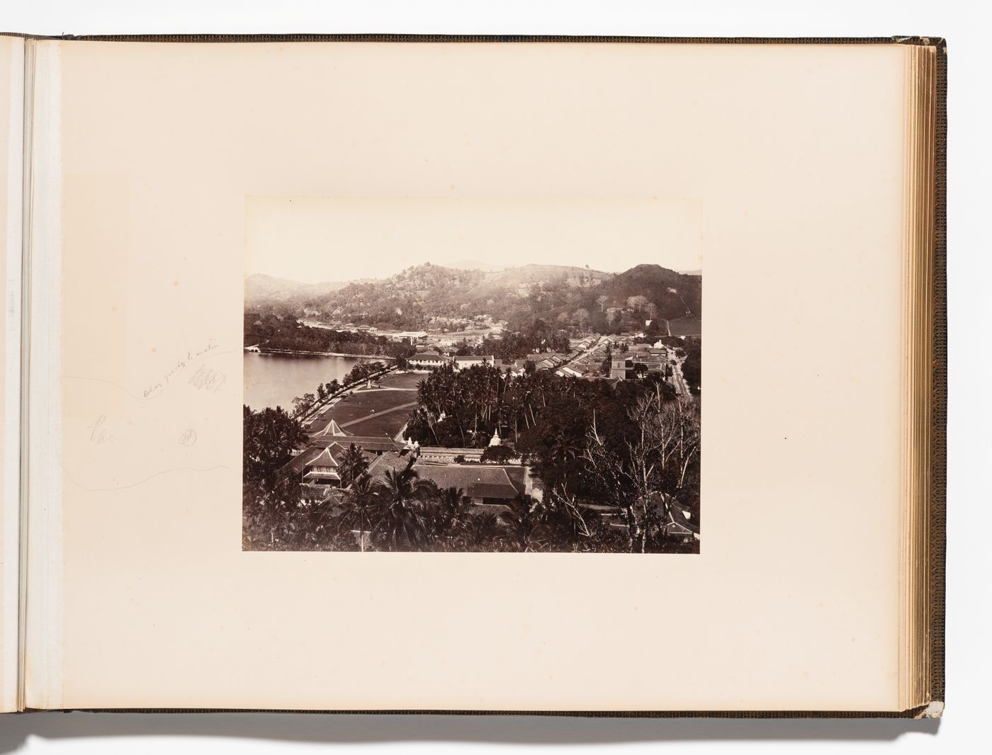 Partial view of Kandy showing buildings and the Temple of the Tooth (also known as the Sri Dalada Maligawa) with Kandy Lake on the left, Ceylon (now Sri Lanka)
