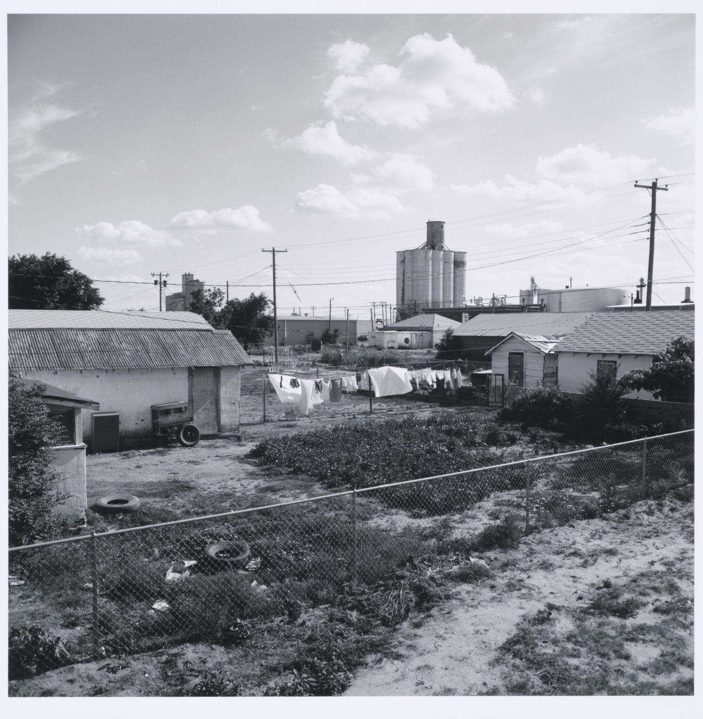 Clothesline in backyard, grain elevators in distance, Tulia, Texas