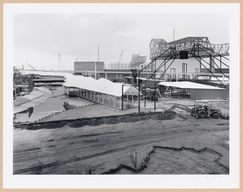 View of the metal framework of the City Gate under construction with covered walkways and the Monorail track in the background, Louisiana World Exposition, New Orleans