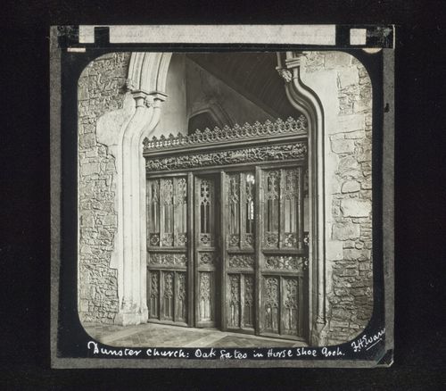 View of oak gates within a horse shoe arch, Dunster Church, Somerset, England
