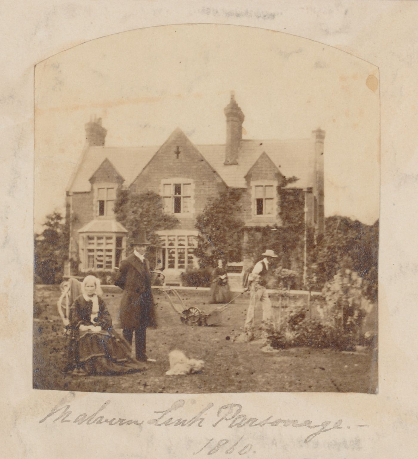 View of a family posing in the front garden of Malvern Link parsonage, Malvern Link, Worchestershire (now Hereford and Worchester), England