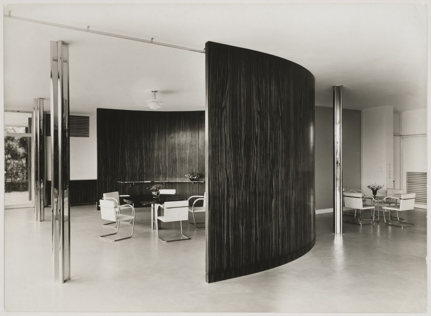 Interior view of Tugendhat House showing the dining alcoves separated by a semicircular partition wall and furniture designed by Mies van der Rohe, Brno, Czechoslovakia (Czech Republic)
