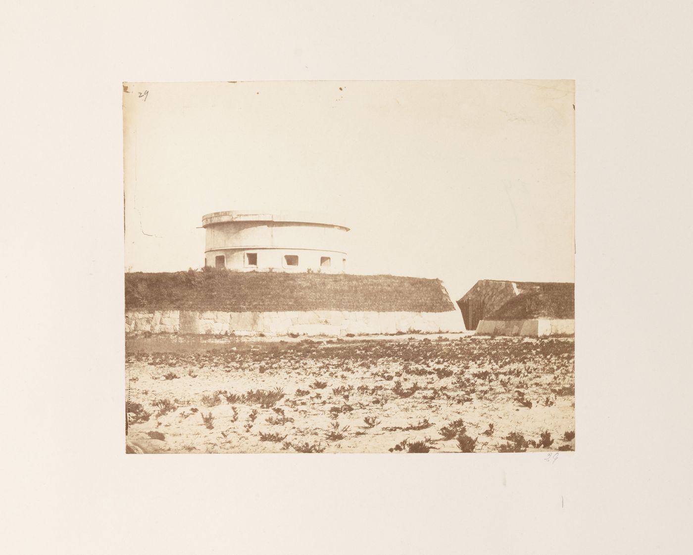View of coastal fortifications showing a martello tower and defensive walls, near Kobe, Japan