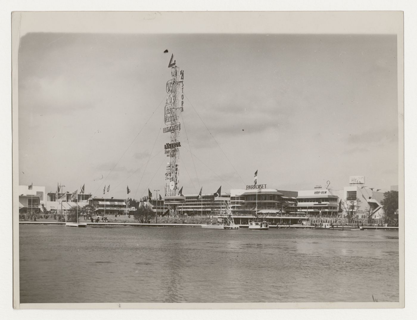 Exterior view of halls 26 and 27, the advertising mast, Paradise Restaurant and the Svea Rike building at the Stockholm Exhibition of 1930, Stockholm