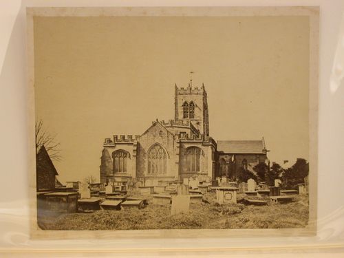 Partial view of a church showing its apse and cemetery in the foreground, England