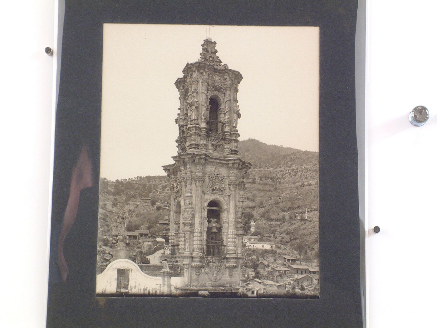 View of the northern tower of the Church of Santa Prisca with buildings and hills in the background, Taxco de Alarcón, Mexico