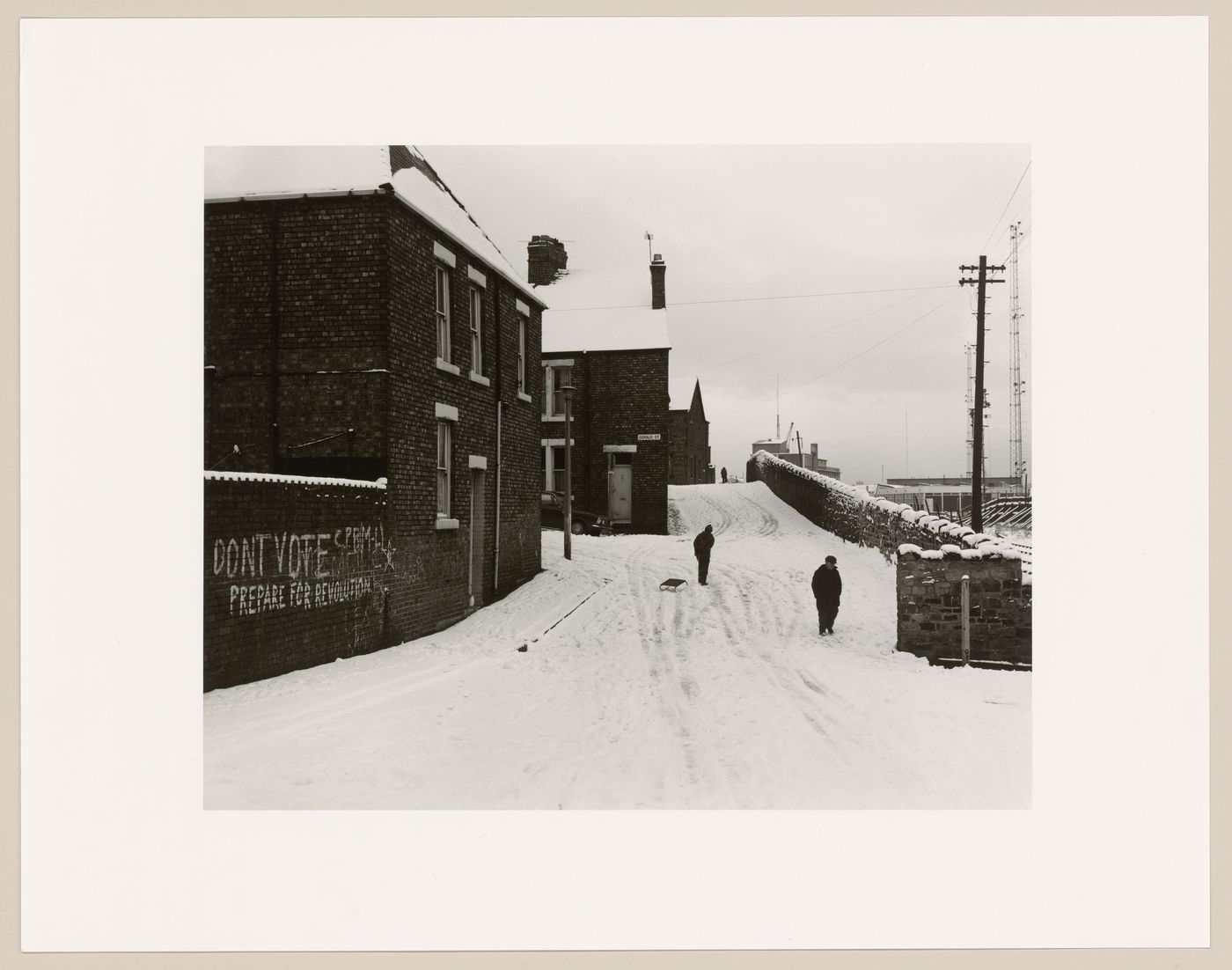 View of stone wall and brick row houses in the snow, Tyne and Wear, England