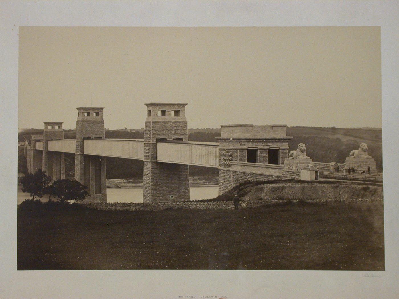 Britannia Tubular Bridge, view of bridge over river, with figures at entrance, Menai Strait, Wales