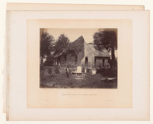 Rear view of Blandford Church (now Old Blandford Church of Bristol Parish) with a soldier and a man in the cemetery, Petersburg, Virginia, United States