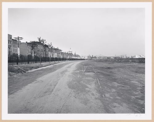 View of an empty lot in the Port of Montréal showing commercial buildings and rue de la Commune on the left with the Bonsecours Market and Pont Jacques-Cartier in the background, Québec