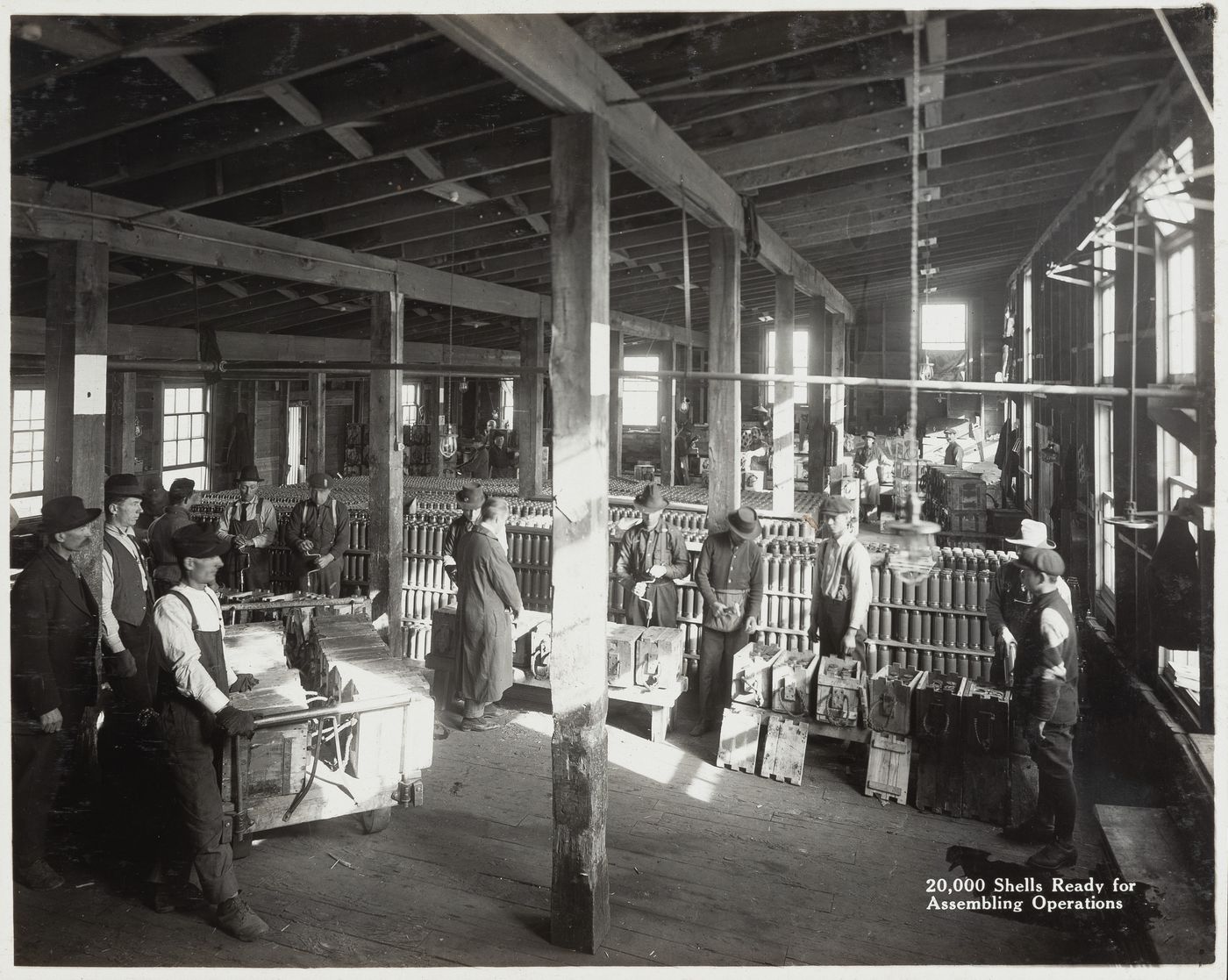 Interior view of workers with 20,000 shells ready for assembling operations at the Energite Explosives Plant No. 3, the Shell Loading Plant, Renfrew, Ontario, Canada